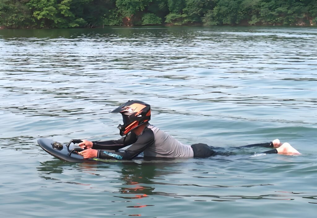 Premium carbon fiber electric surfboard placed on wet sand during sunset